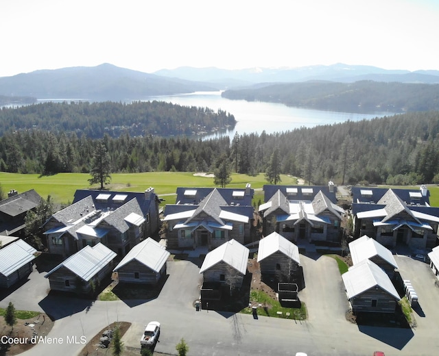 drone / aerial view featuring a residential view and a water and mountain view