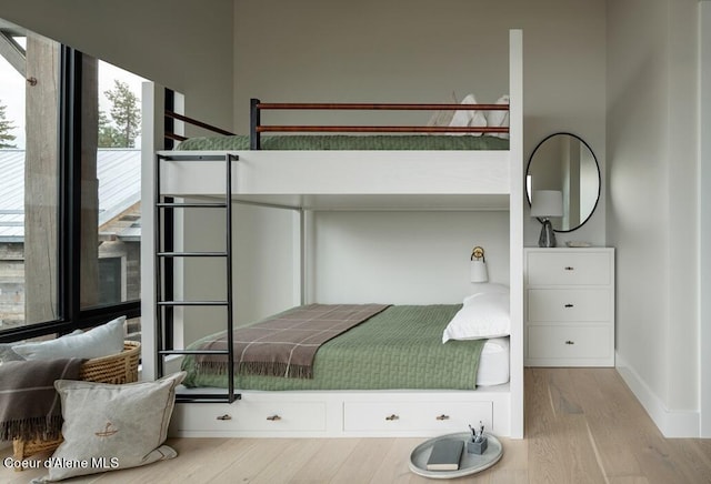 bedroom with light wood-type flooring and baseboards