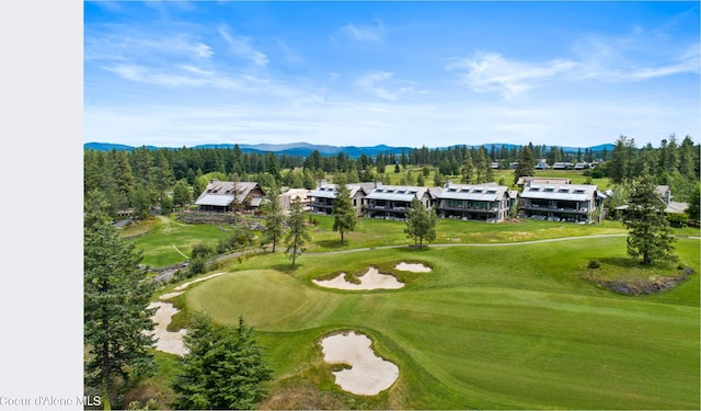 drone / aerial view with view of golf course and a mountain view