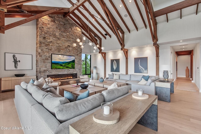 6895 S Gozzer Rd Unit A201, Harrison, ID 83833 - living room with light wood-type flooring, a stone fireplace, high vaulted ceiling, and beamed ceiling