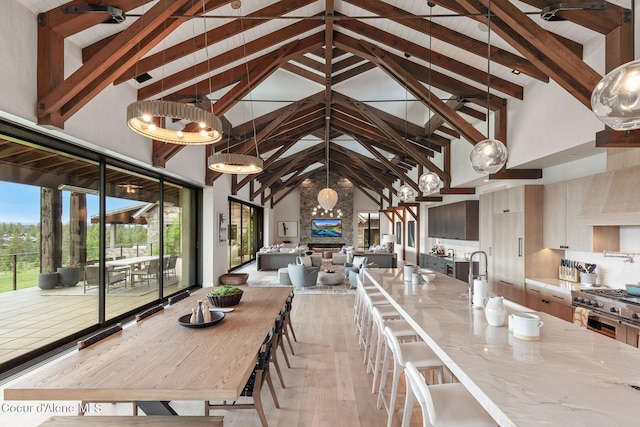 6895 S Gozzer Rd Unit A201, Harrison, ID 83833 - dining space featuring high vaulted ceiling, light wood finished floors, and wood ceiling with exposed beams