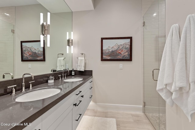 6895 S Gozzer Rd Unit A201, Harrison, ID 83833 - bathroom featuring double vanity, a shower stall, and baseboards