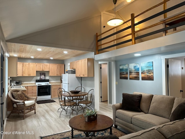 living room with high vaulted ceiling, recessed lighting, light wood-type flooring, and a toaster