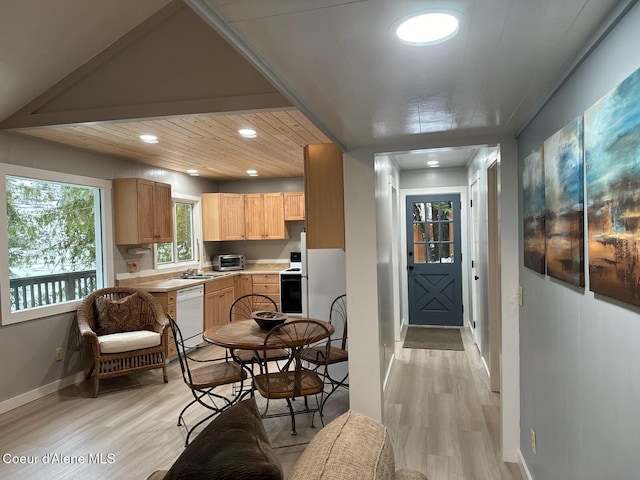 kitchen featuring light countertops, electric range oven, light wood-style floors, light brown cabinets, and white dishwasher