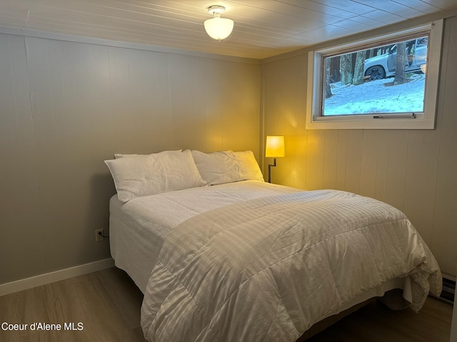 bedroom with baseboards and wood finished floors