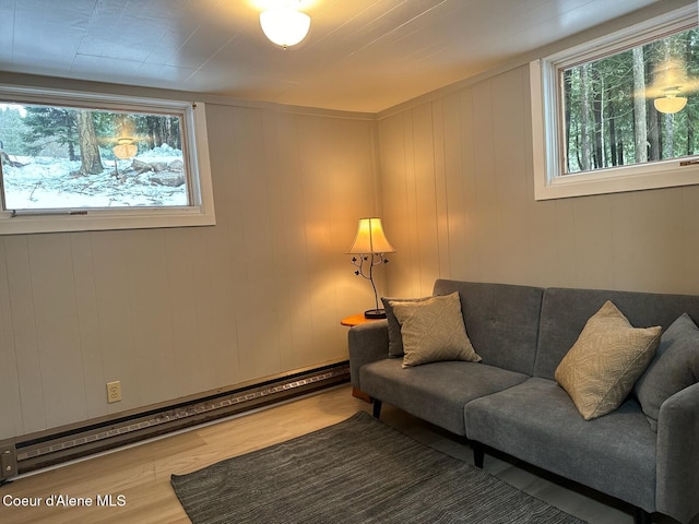 living room featuring baseboard heating and wood finished floors