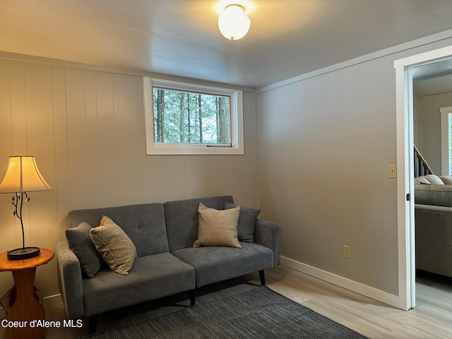 living room featuring light wood-type flooring and baseboards