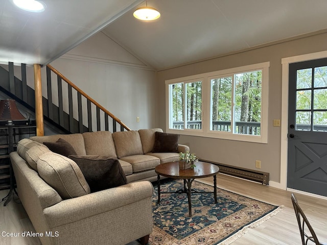 living room with vaulted ceiling, stairway, baseboard heating, and wood finished floors