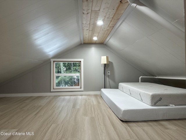 unfurnished bedroom with lofted ceiling, wood ceiling, baseboards, and wood finished floors