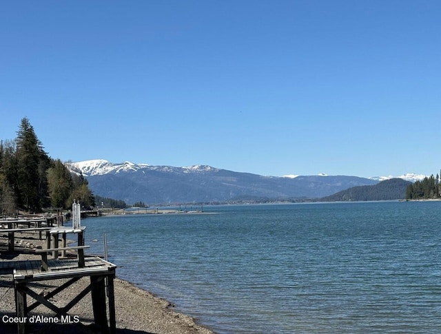 water view featuring a boat dock and a mountain view