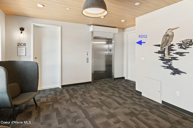 corridor with recessed lighting, wood ceiling, baseboards, dark carpet, and elevator