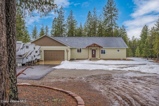 ranch-style home featuring a garage and driveway