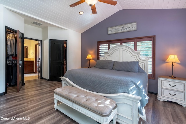 bedroom with baseboards, visible vents, lofted ceiling, ceiling fan, and wood finished floors