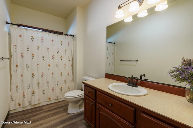 full bathroom with a shower with shower curtain, vanity, toilet, and wood finished floors