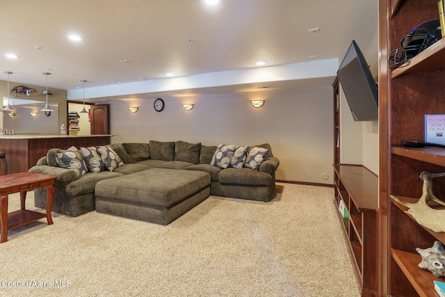 carpeted living room featuring baseboards and recessed lighting