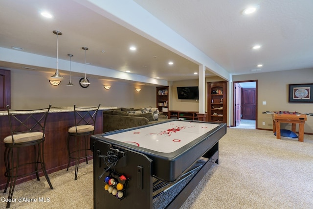 game room featuring a bar, recessed lighting, baseboards, and light colored carpet