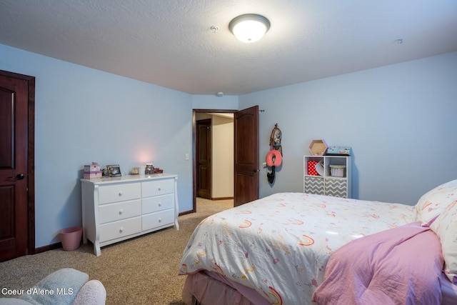 bedroom with light colored carpet, a textured ceiling, and baseboards