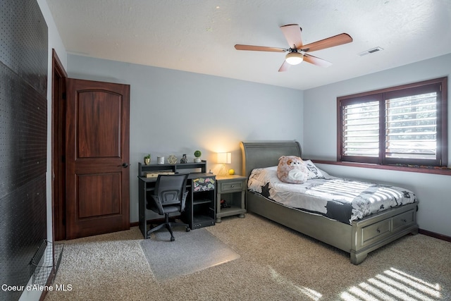 bedroom with light colored carpet, visible vents, a ceiling fan, a textured ceiling, and baseboards