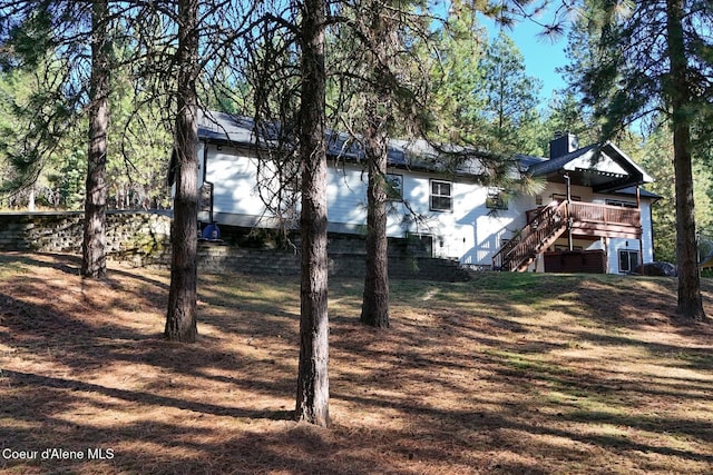 exterior space featuring a chimney, stairway, and a deck