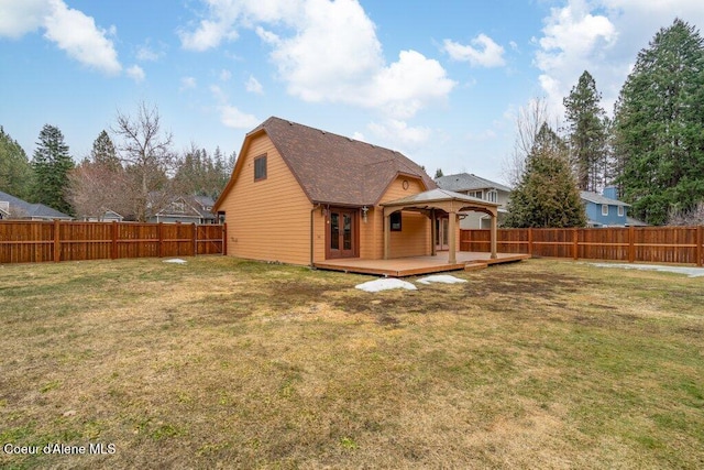 back of property featuring a deck, a gazebo, a lawn, and a fenced backyard