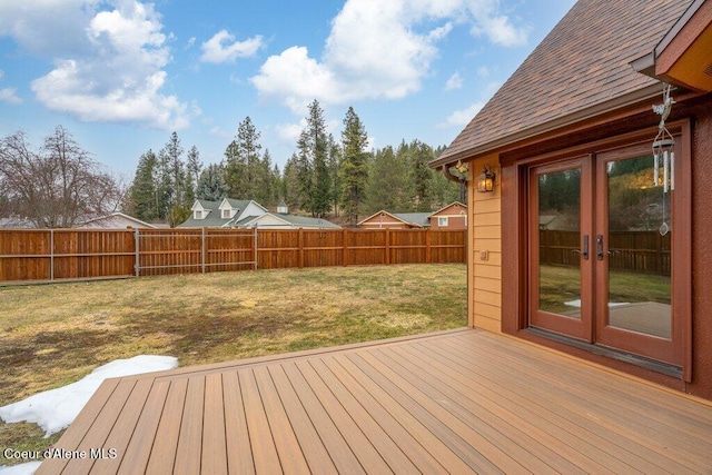 wooden deck with french doors, a fenced backyard, and a yard