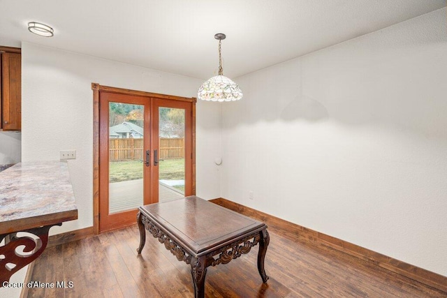 dining room with wood-type flooring, baseboards, and french doors