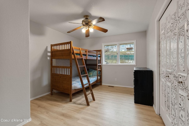 bedroom with light wood-style flooring and baseboards