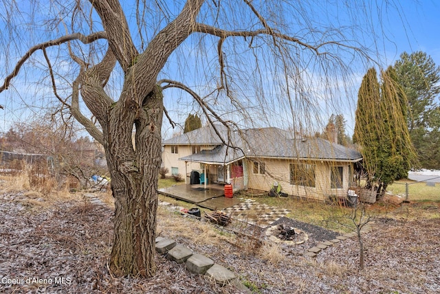 exterior space with a chimney, a fire pit, and a patio