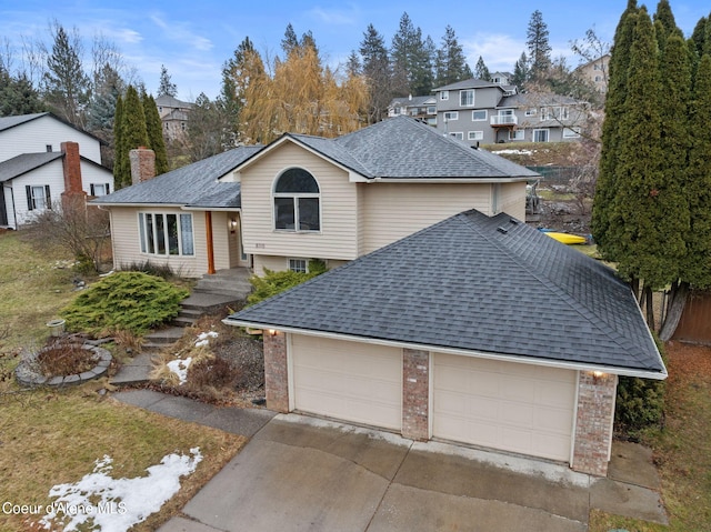 view of front of property featuring brick siding, a chimney, a shingled roof, a garage, and driveway