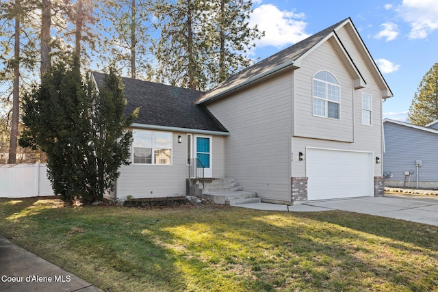 view of front of house featuring concrete driveway, roof with shingles, an attached garage, fence, and a front yard