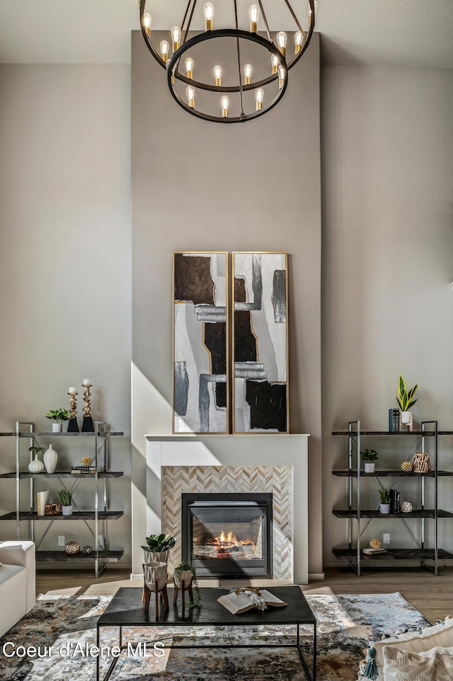 living area featuring a tiled fireplace and wood finished floors