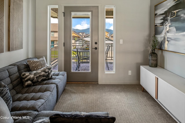 doorway featuring baseboards and carpet flooring