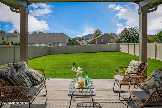 view of yard with a patio, outdoor lounge area, a fenced backyard, and a mountain view