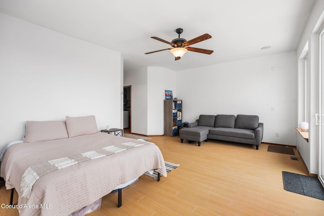 bedroom featuring visible vents, ceiling fan, and light wood-style flooring