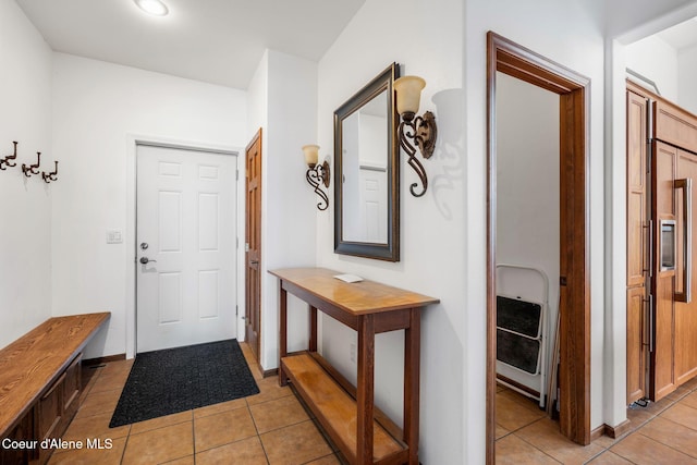 interior space with light tile patterned flooring and baseboards