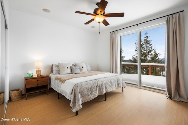 bedroom with ceiling fan, light wood-style flooring, and access to outside