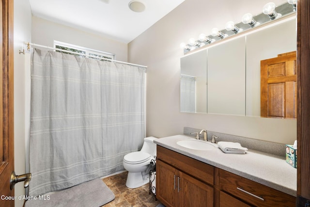 bathroom with toilet, vanity, and a shower with curtain