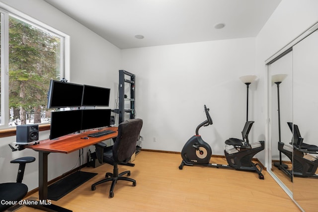 home office featuring light wood-type flooring and baseboards