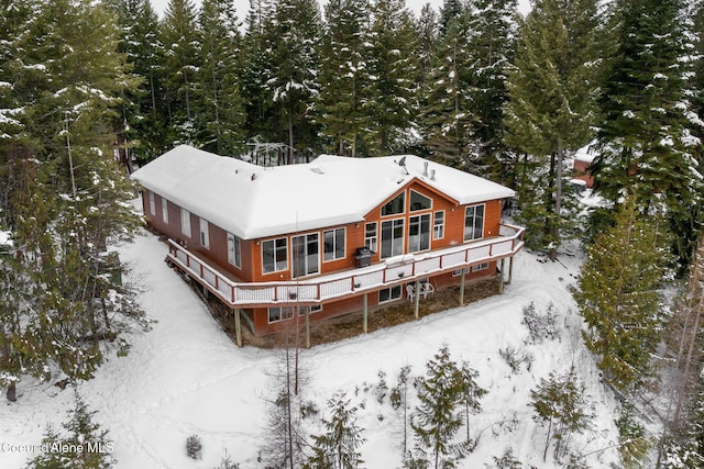 view of snow covered rear of property