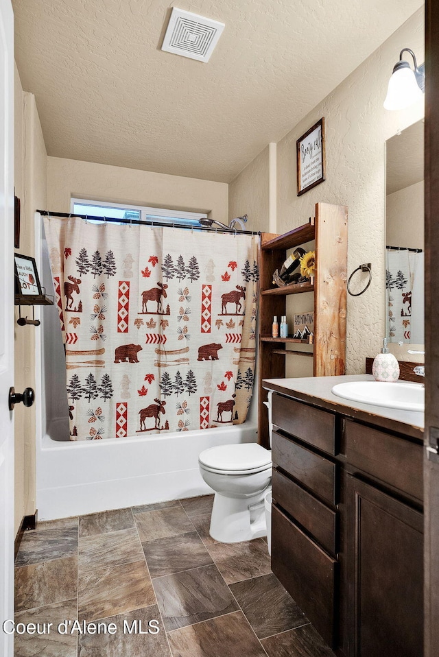 bathroom with vanity, shower / bathtub combination with curtain, a textured wall, a textured ceiling, and visible vents