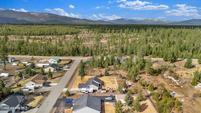aerial view with a wooded view and a mountain view