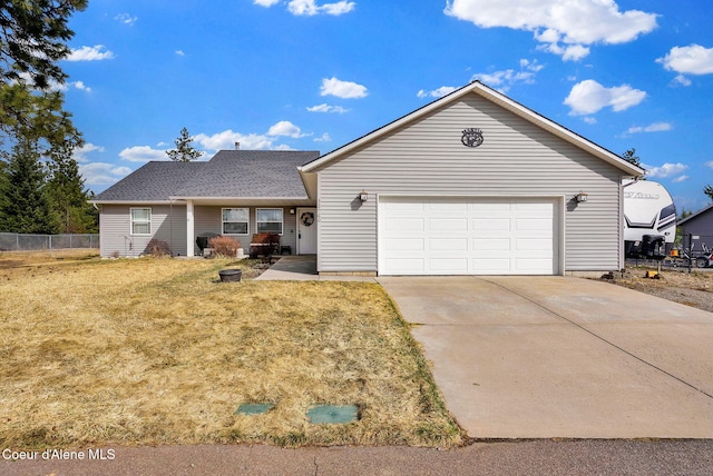 ranch-style house featuring fence, a front yard, an attached garage, and concrete driveway