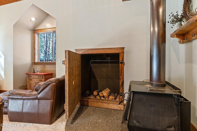 interior space with lofted ceiling, a glass covered fireplace, and recessed lighting