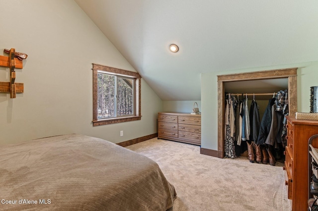 bedroom featuring carpet floors, a closet, vaulted ceiling, and baseboards