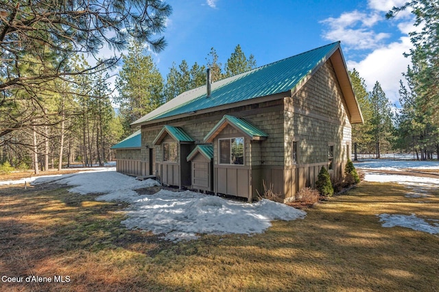 view of snowy exterior featuring metal roof