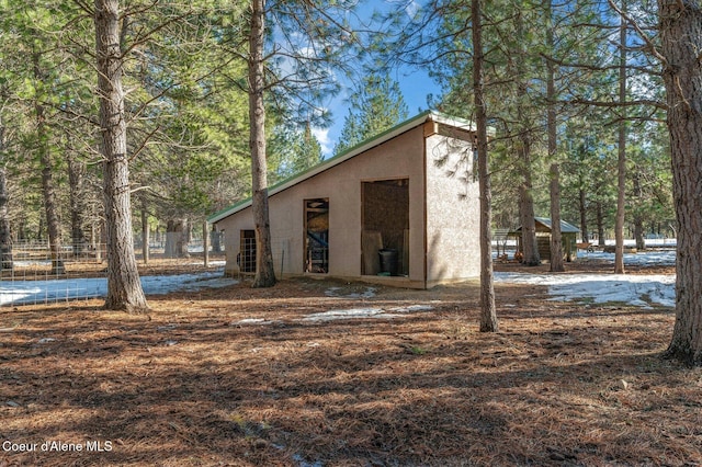 rear view of house with an outbuilding and stucco siding