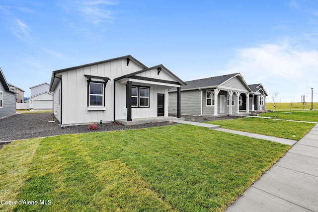 view of front of home featuring a porch, board and batten siding, and a front yard