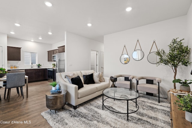 living area featuring light wood-style flooring and recessed lighting