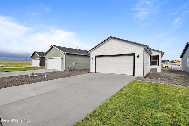 ranch-style house with a front yard, cooling unit, and an outbuilding