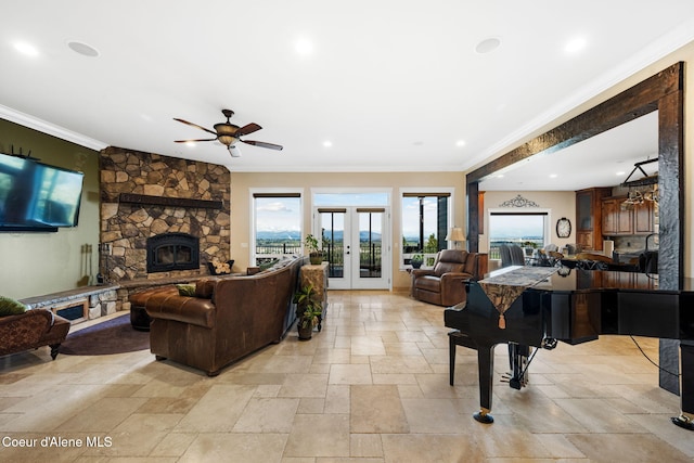 living room featuring french doors, a fireplace, recessed lighting, stone tile flooring, and ornamental molding